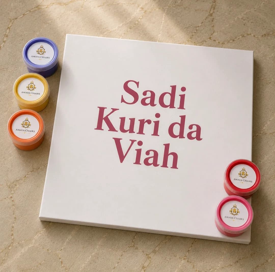 A personalised Maiyan board printed with “Sadi Kuri da Viah”, surrounded by pots of coloured powder.