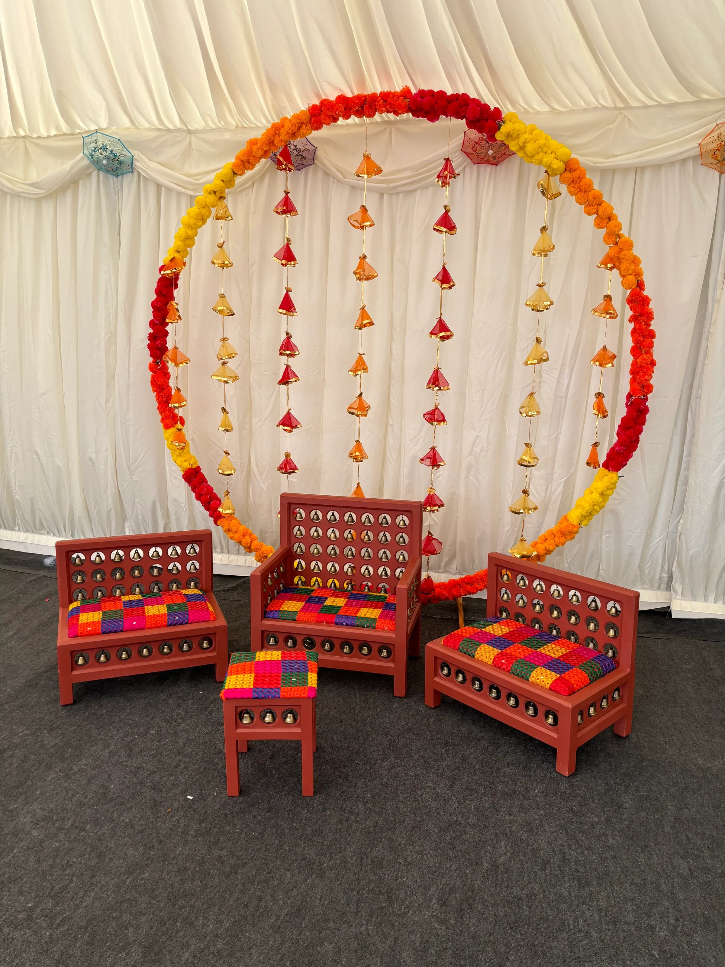 The Satrang suite inside a marquee, under a ring of marigolds and hanging tassels.