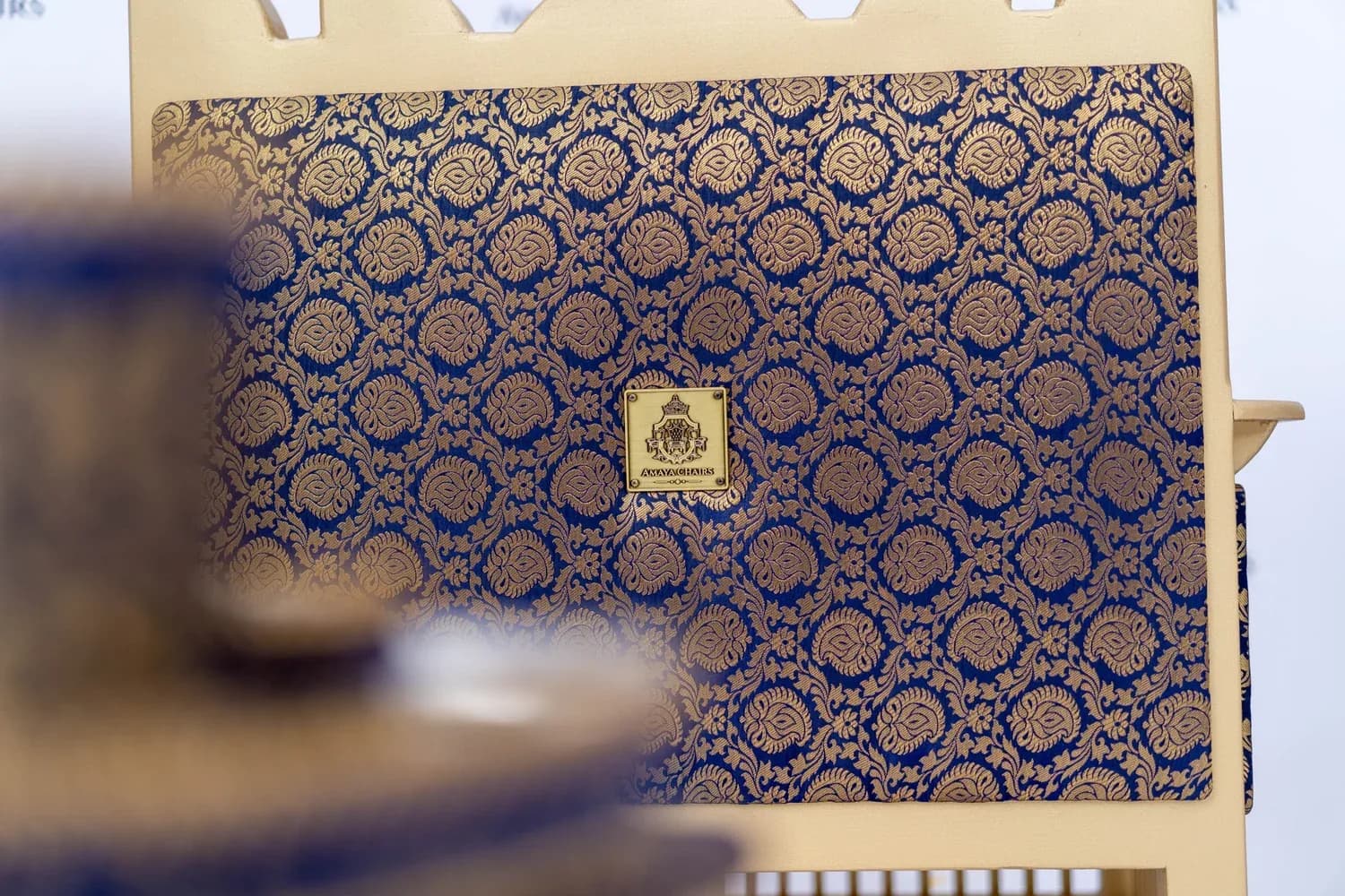 Detail of the dark gold-and-black brocade upholstery on a Majestic Lion bench.