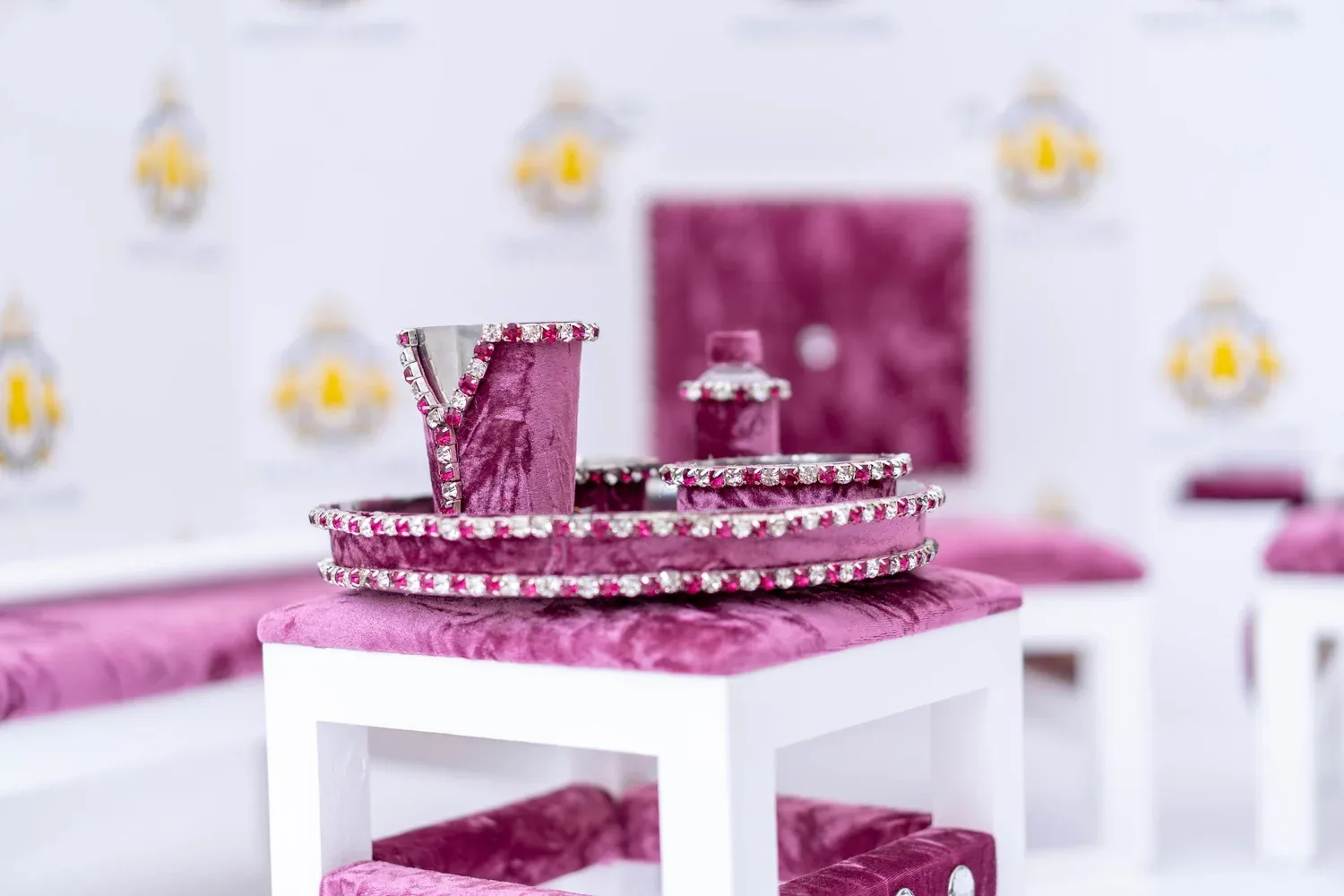 The Rose Quartz tray table dressed with the brass Sagan tray, beside the white-framed bench.
