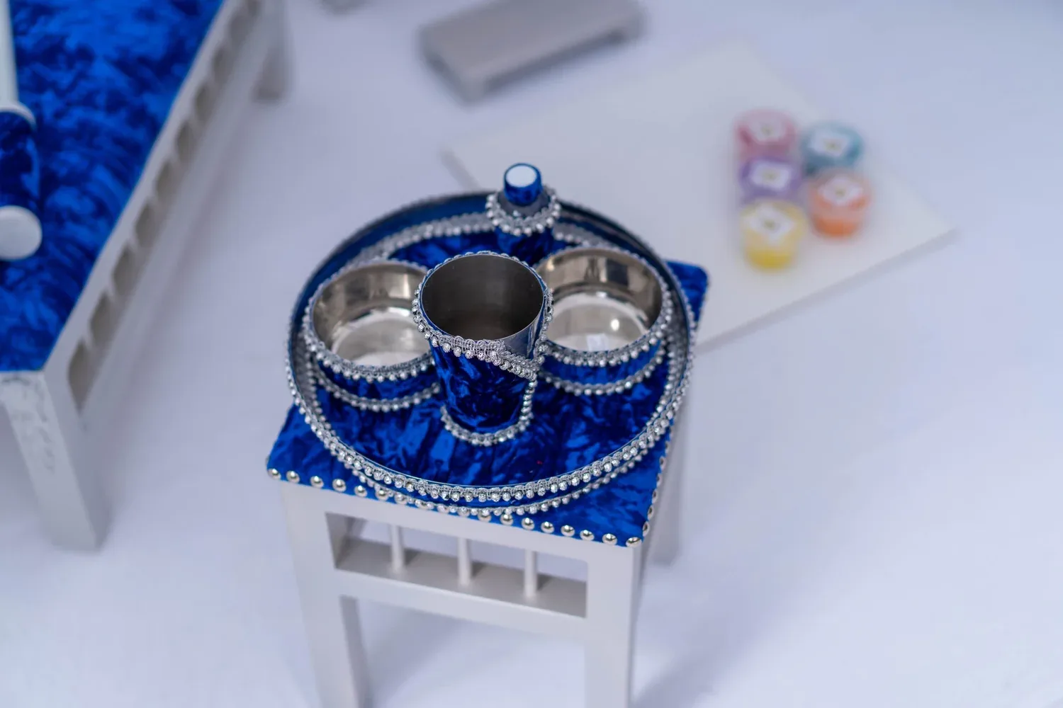 The Blue Prince tray table with the brass Sagan tray, ceremony bowls and pots of rangoli colour.